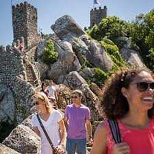 A group of people standing on a rockDescription generated with very high confidence